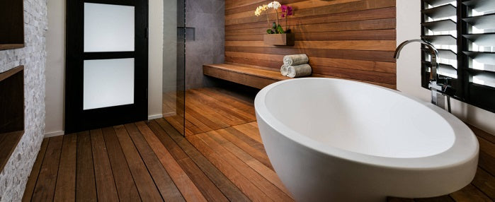 Waterproof solid thermally modified wood used for real-wood shower walls and bathroom flooring.